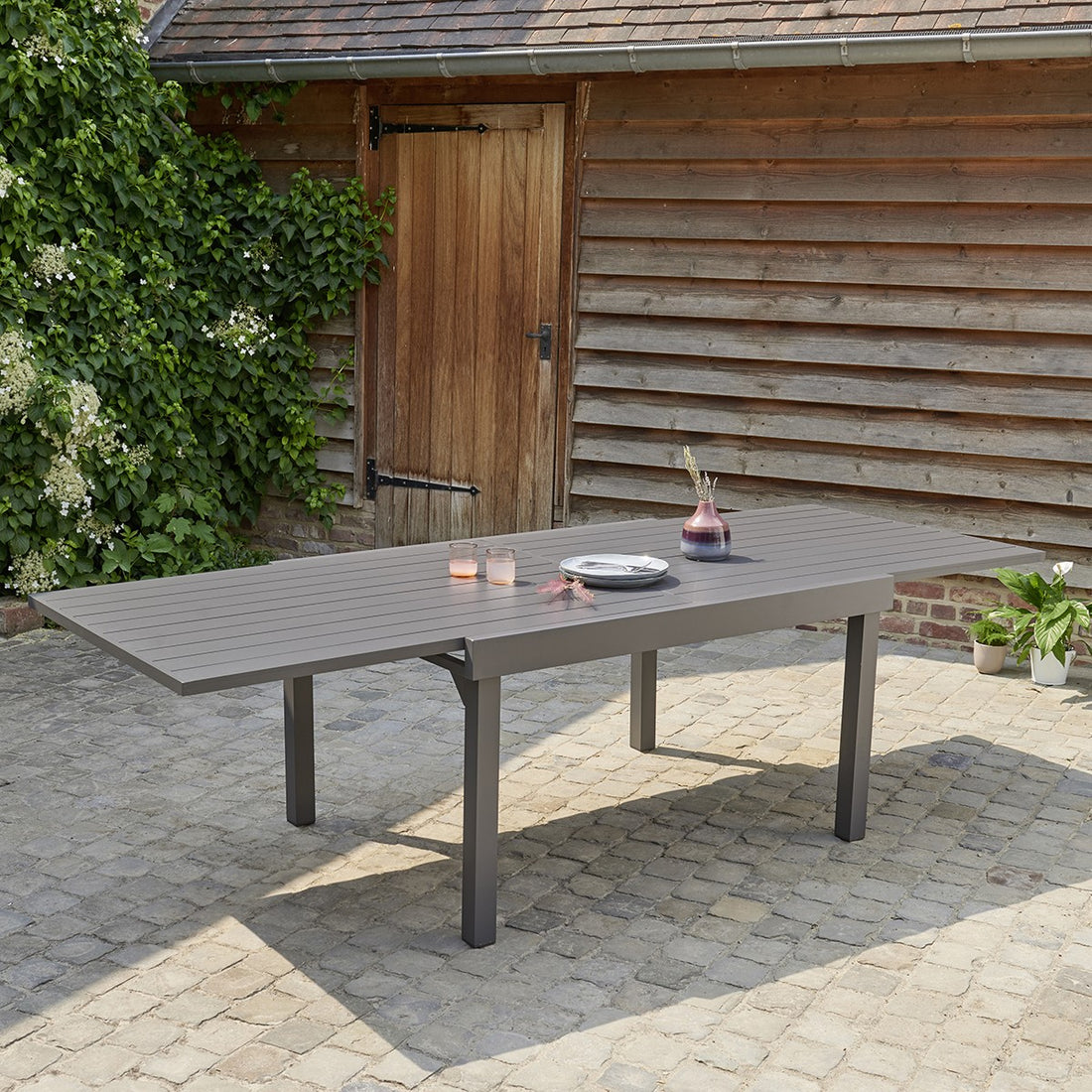MODULO - Mesa de exterior extensible de aluminio gris para 6/10 pers. MODULO