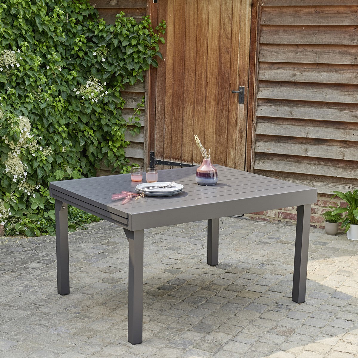 MODULO - Mesa de exterior extensible de aluminio gris para 6/10 pers.