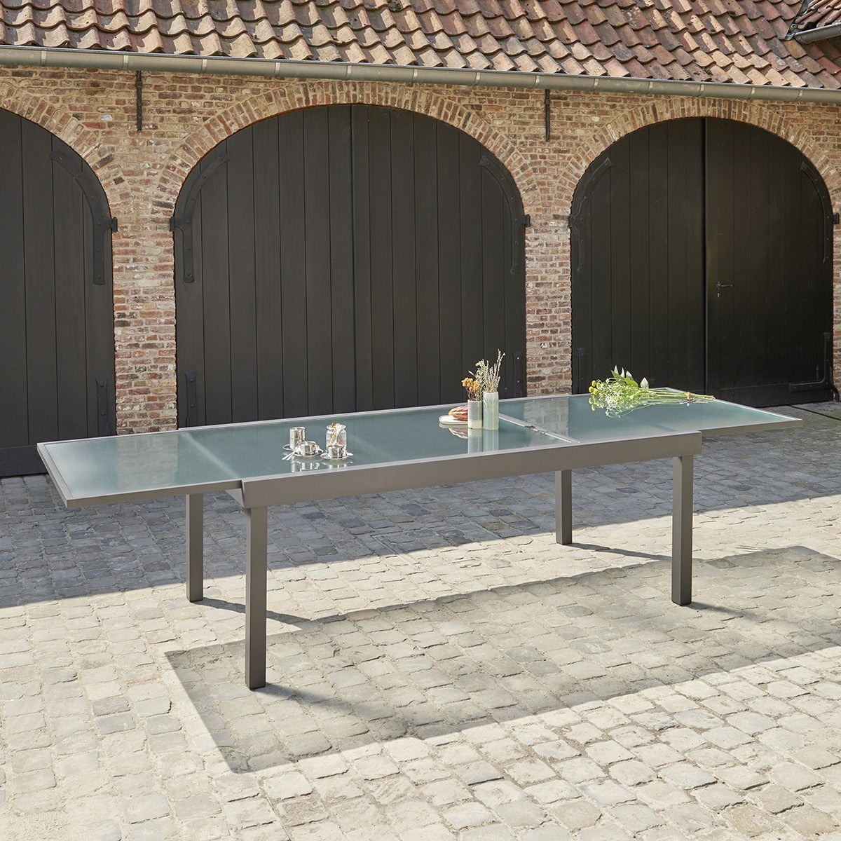 MODULO - Mesa de exterior extensible de aluminio gris para 8/12 pers.
